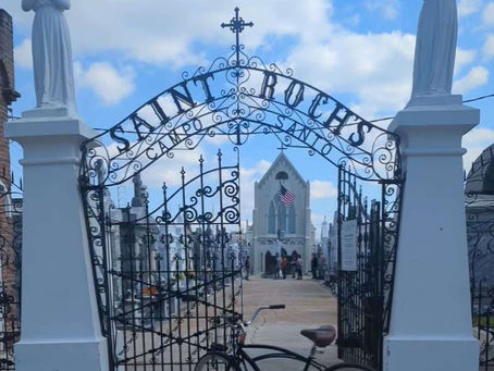 A bicycle in front of the Iron front gates of the St Roch  Cemetery