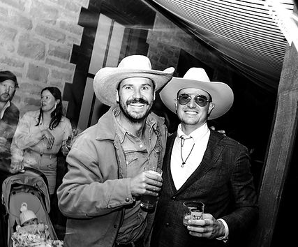 two men in country attire at a festival