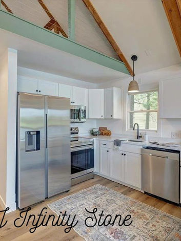 Carmel, IN kitchen in bright white with white counters and white cabinets and stainless steel appliances