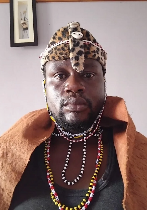 Spiritual David wearing traditional spiritual attire and beaded necklaces