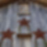 (Photo by sizzle&STEM) Picture of 3 brass stars on the front wall of the Meadow Mist Farm Barn entrance