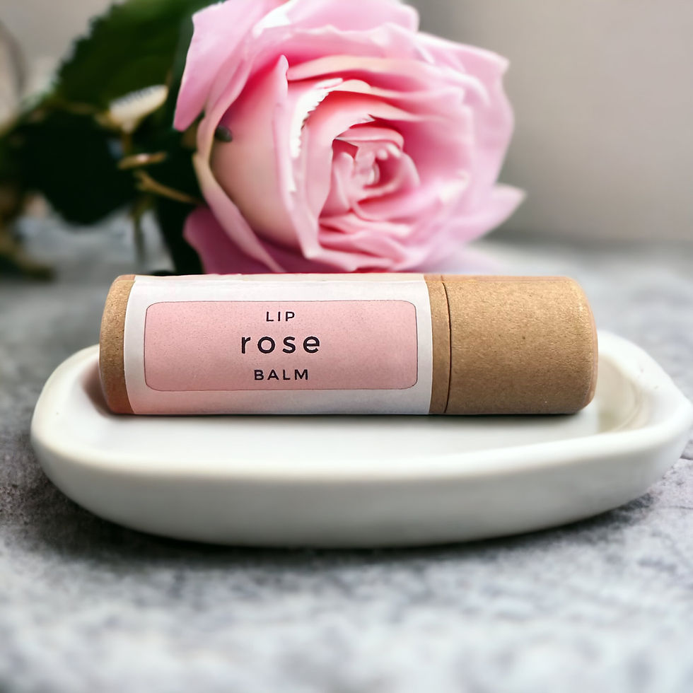 Rose Lip Balm in compostable tube, styled with dried rose petals