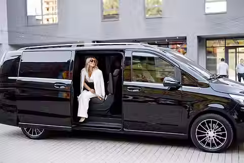 elegant-business-lady-white-looks-out-minivan-taxi-concept-business-trips-transportation_5