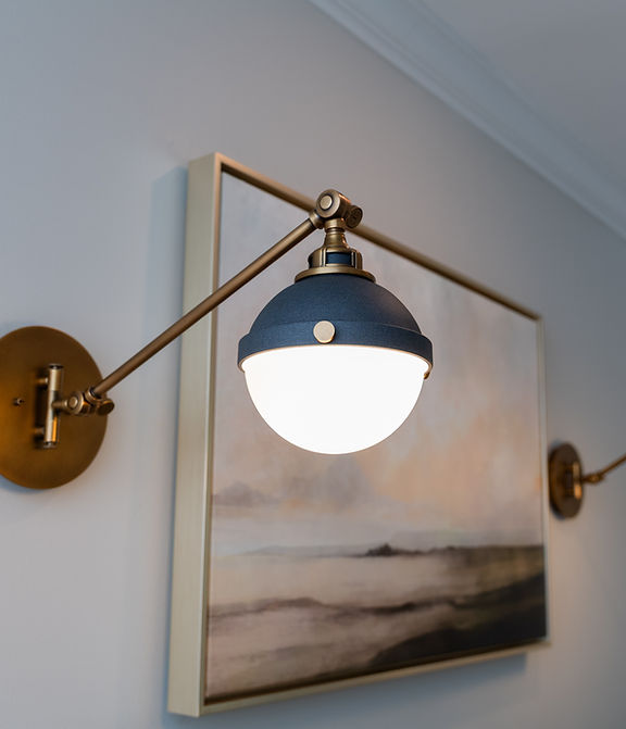 wall sconces flanking a piece of wall art