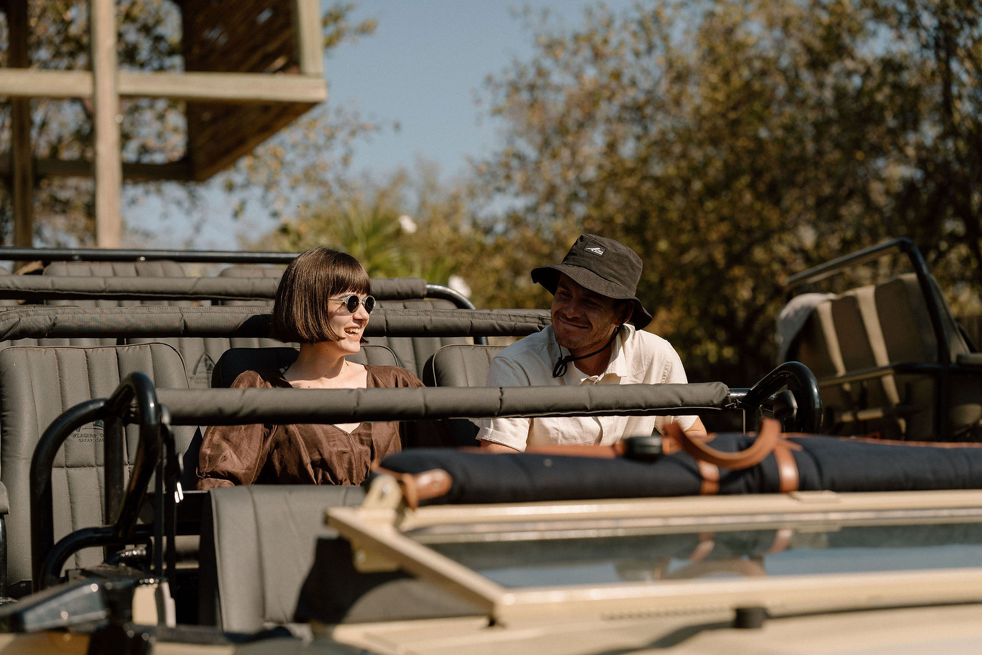 wedding guests on safari vehicle waiting to depart