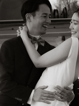 Black and White images of couple dancing in the headlights of Safari Vehicle while on their honeymoon and dressed in their wedding attire.