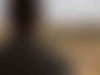 Groom looking out over bush veld in front of Wedding suite at Klaserie Drift Safari Camp