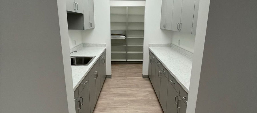 Interior view of medical office room with cabinets and storage area Waterman Consulting Services