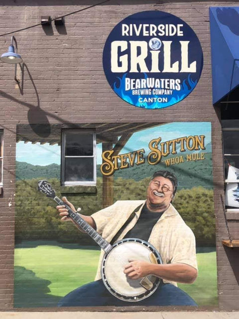 A mural of a banjo player on the side of a building