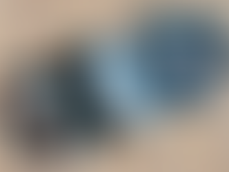 Five pairs of children's underwear with various patterns and colors, including stripes, stars, and vehicles, are laid on a wooden surface.