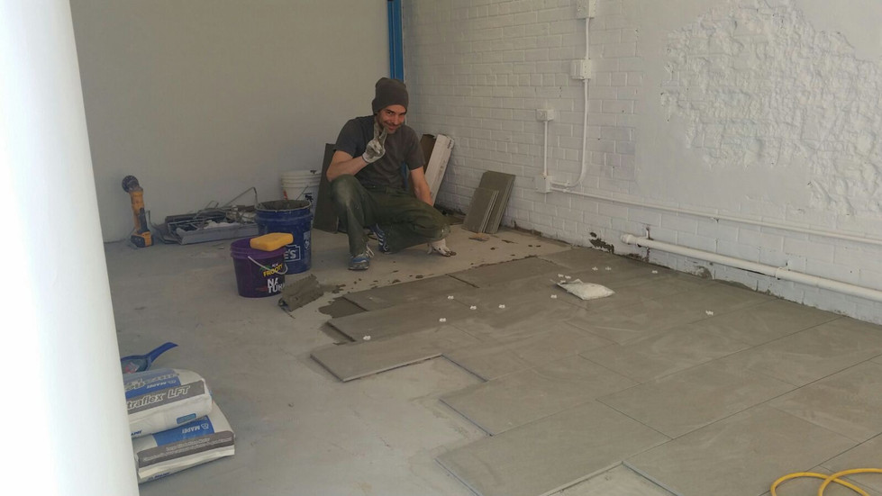 person laying tiles