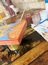 Inscribing the saint's name in calligraphy on a completed icon.