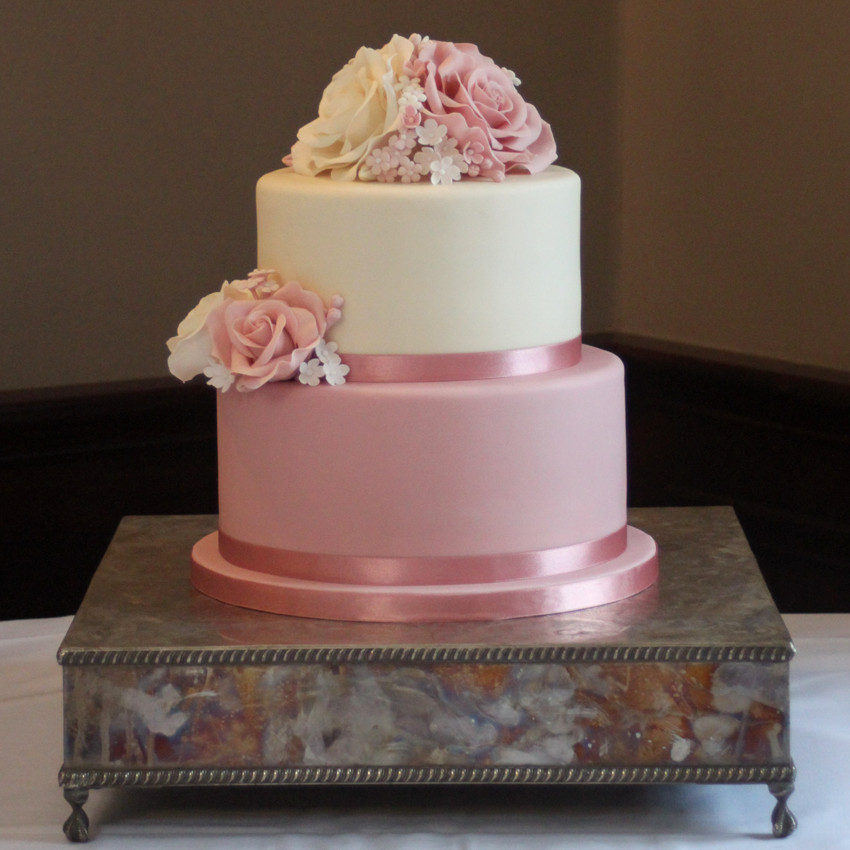 Two tier wedding cake with pink and ivory sugar roses