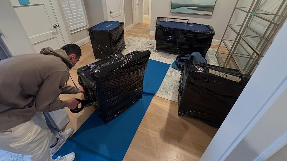 Yeah That Movers team member preparing furniture with pads and plastic for protection on a move