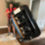 David from Yeah That Movers confidently lifting a full-size sofa, showcasing strength, balance, and control during a white-glove move in Upstate South Carolina.