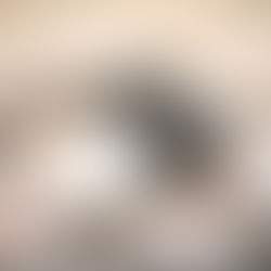 Stacked books and black headphones on a blanket