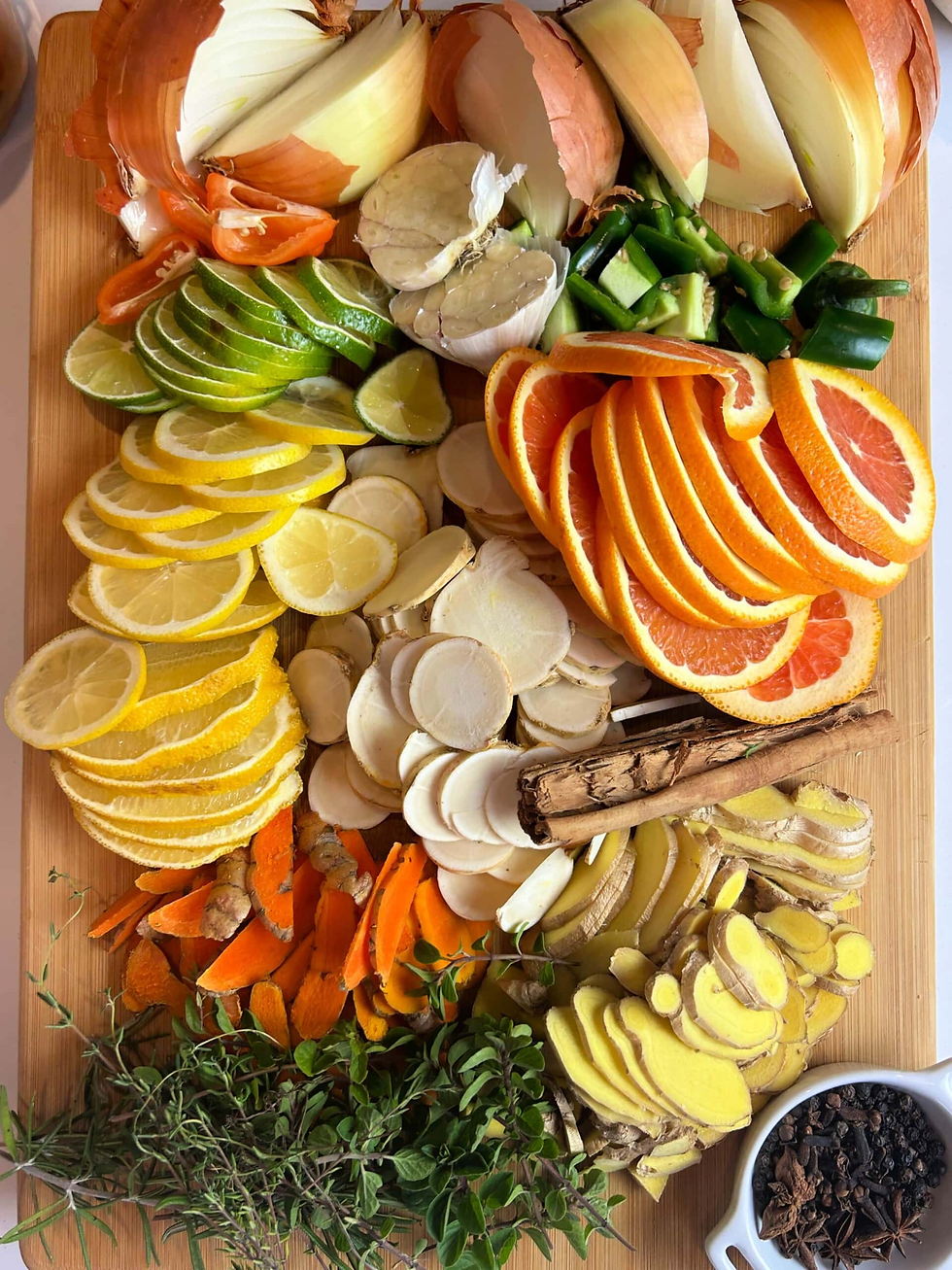 Sliced citrus fruits, onions, garlic, spices, and herbs arranged on a wooden board, showcasing vibrant colors and fresh ingredients.