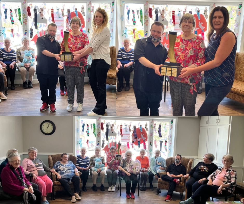 The Golden Sock Award is presented to Rosewood RVilla for being the 2025 winner of the Lots of Socks Window Display Contest in support of World Down Syndrome Day.