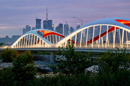 Night view of Commissioners Street Bridge with vehicle light trails in Toronto