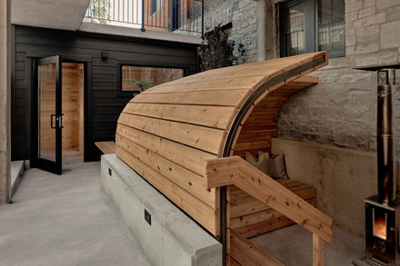 Outdoor fire pit and cedar sauna overlooking the landscaped courtyard of the Belvedere Hotel Bathhouse Spa.
