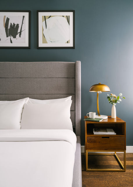 Stylish guest suite with neutral tones and framed artwork, captured by Toronto hospitality photographer Jacob Côté