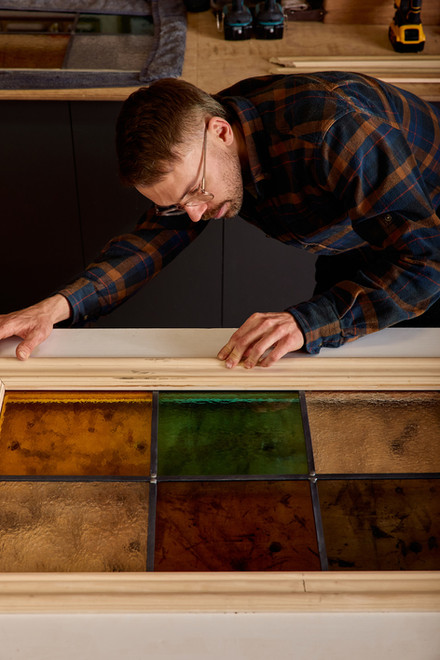 Close moment of Nick assembling custom door pieces in his Toronto-based workshop