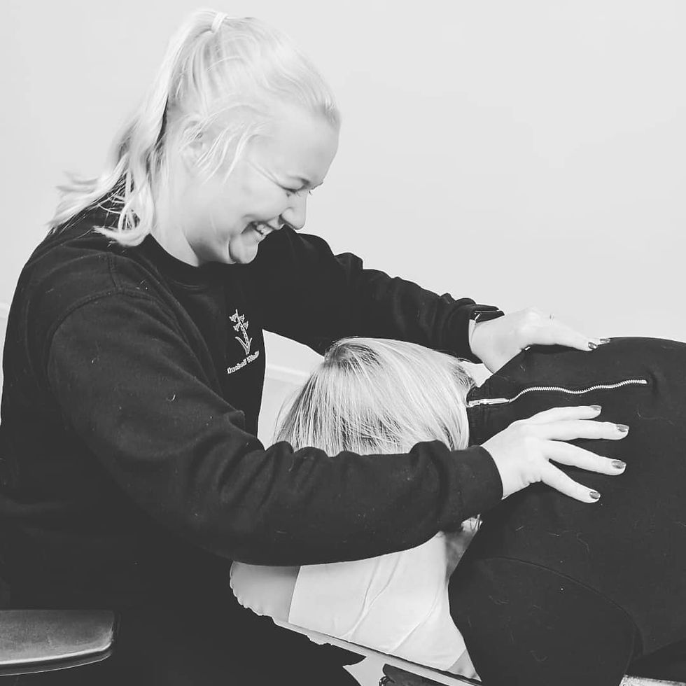 A chiropractic adjustment being performed on a patient