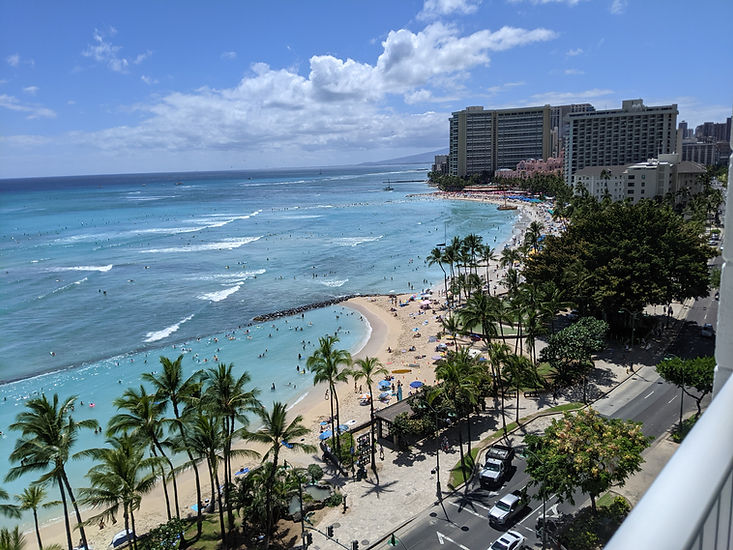Waikiki Beach coastline view from high-rise hotel room in Hawaii luxury oceanfront travel experience