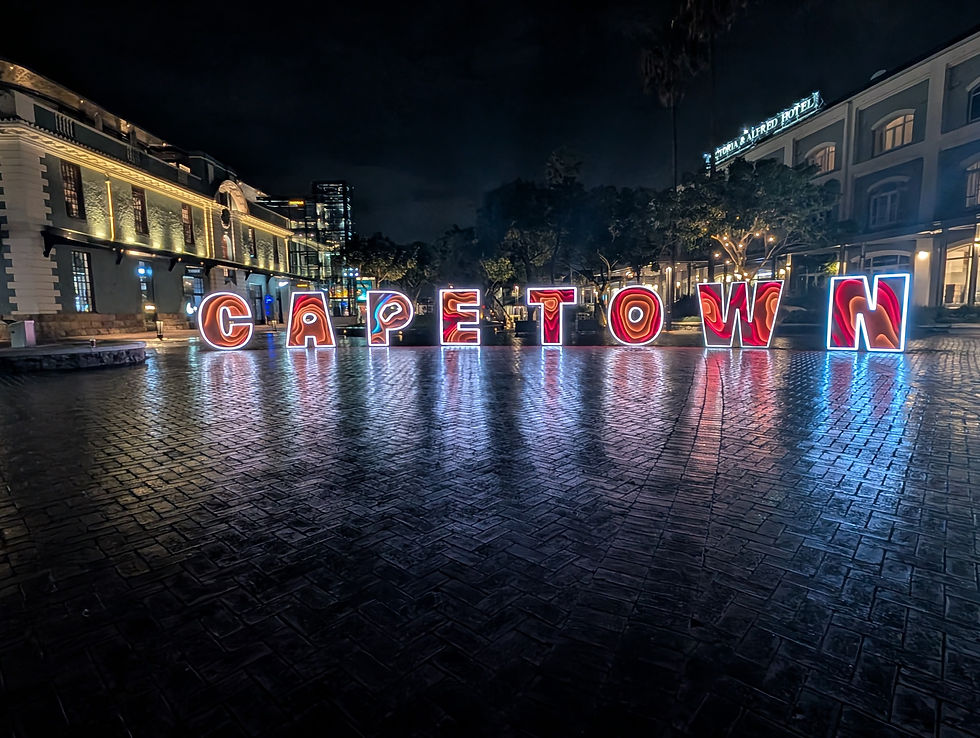 The "Cape Town" sign was illuminated at night right outside of the Time Out Market