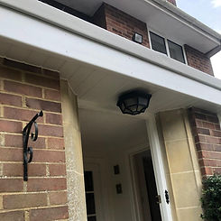 New white uPVC fascias, soffits, and guttering installed on a brick home in Dorset for a clean, maintenance-free finish.
