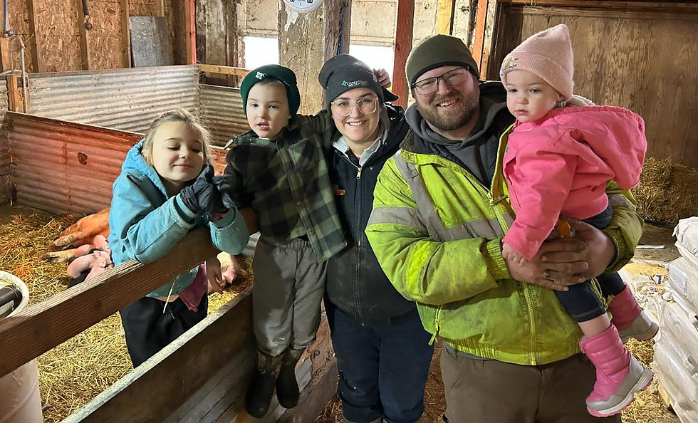 Kenneke family photo with pigs in background