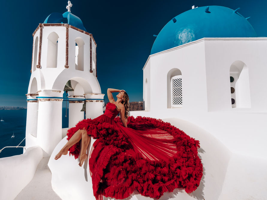 affordable flying dress photoshoot santorini greece near blue domes