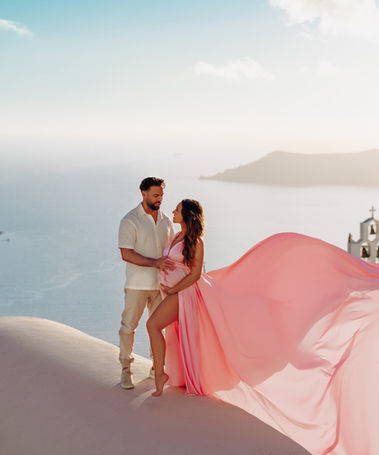 Elegant maternity flying dress photography in Imerovigli at sunset