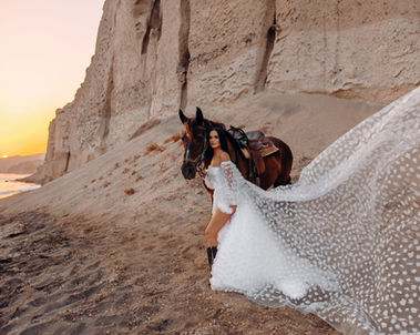 Flying dress photoshoot with horse in Santorini at sunset