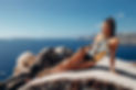 sexy girl in golden corset in Oia with caldera view