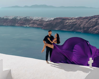 Cinematic couple flying dress photoshoot overlooking the caldera
