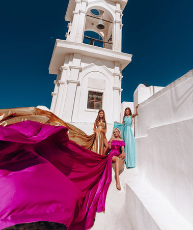 Santorini family photography during golden hour near blue doems 