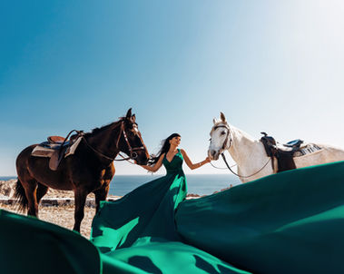 Santorini beach horse photoshoot with flowing flying dress