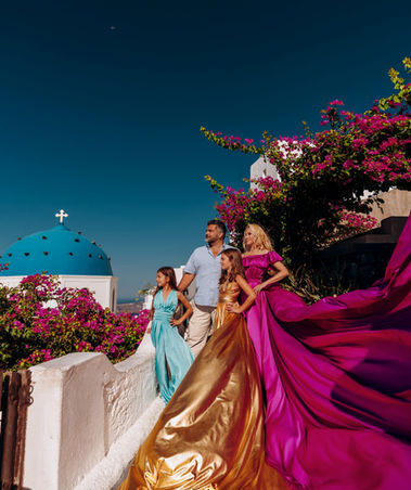 Luxury family flying dress photoshoot in Santorini