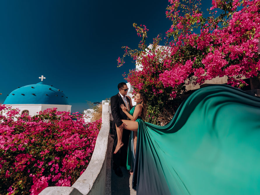 woman flying dress imerovigli volcano background santorini