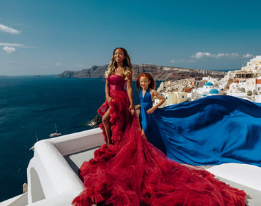 Family flying dress photoshoot in Oia Santorini