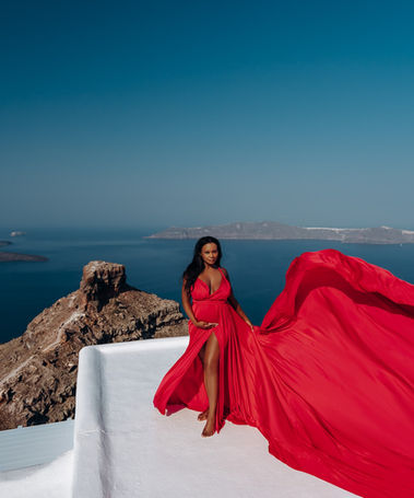 Maternity flying dress photoshoot in Imerovigli Santorini with caldera views