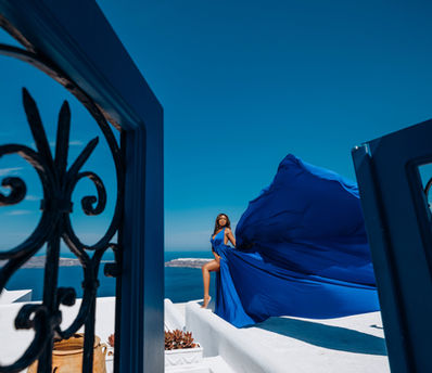Editorial flying dress portrait in Imerovigli Santorini