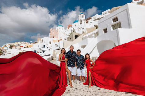 Family photoshoot with kids in Santorini sunset caldera near blue domes