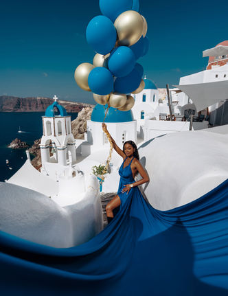 Editorial fashion portrait with flowing dress in Santorini