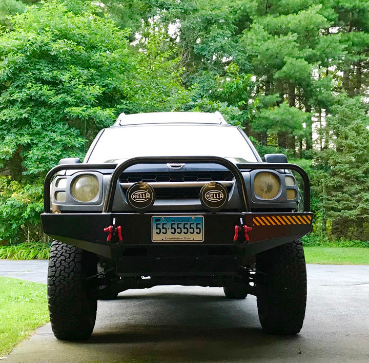 Front end shot of a 2002 Xterra with a big winch bumper.