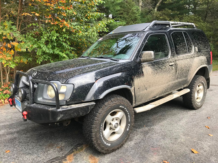 A muddy 2002 Xterra 4x4.