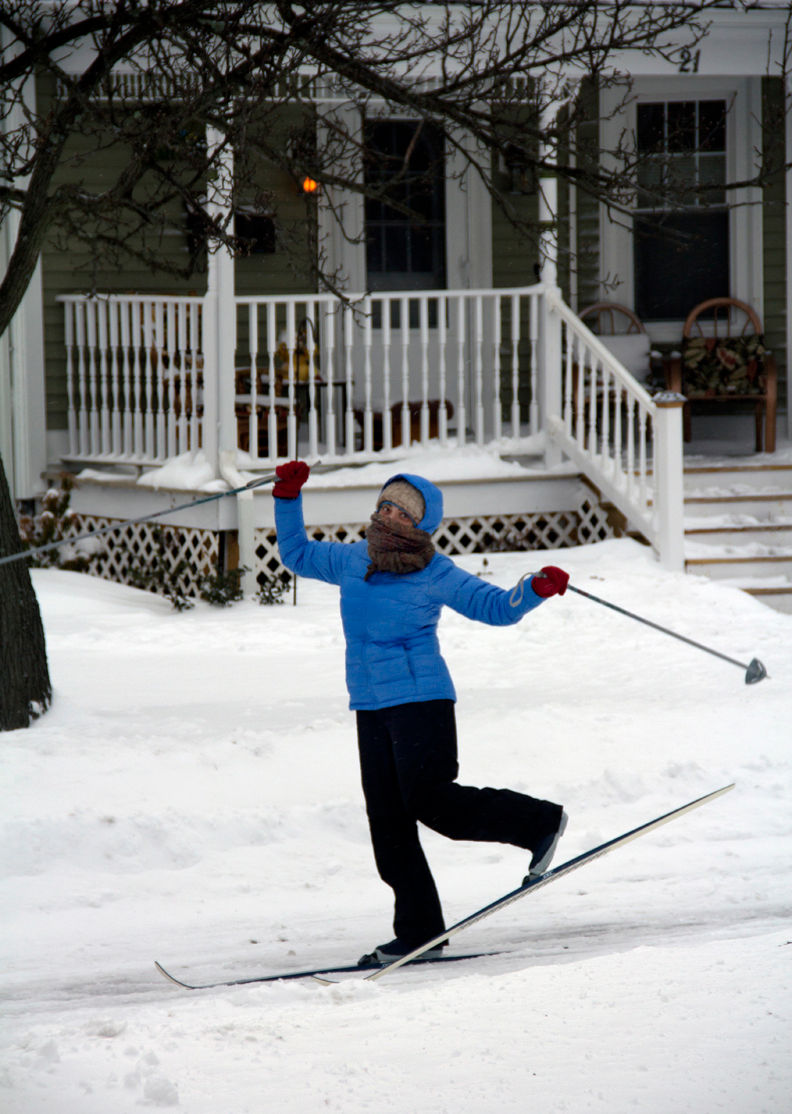 The author's lovely wife cross-country skiiing down the street in winter.