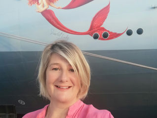 Wendy Byard in front of Virgin Voyages Scarlet Lady