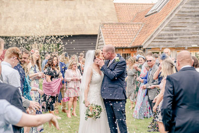 wedding couple covered in confetti